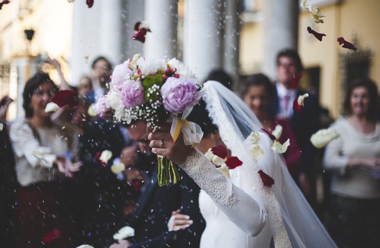 Bride and groom holding hands in soft sunlight